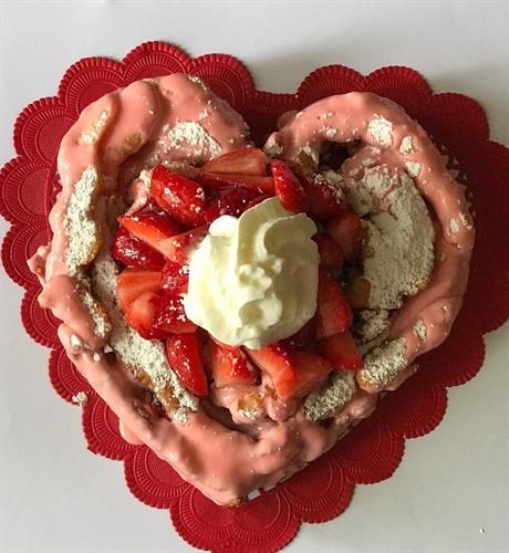 Strawberry Supreme Delight/Funnel cake with strawberry drizzle, fresh strawberries, and whipped topping.