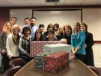 Team Santo worked to purchase, wrap and deliver "Christmas" to two needy families made up of 11 individuals through Project Bethlehem