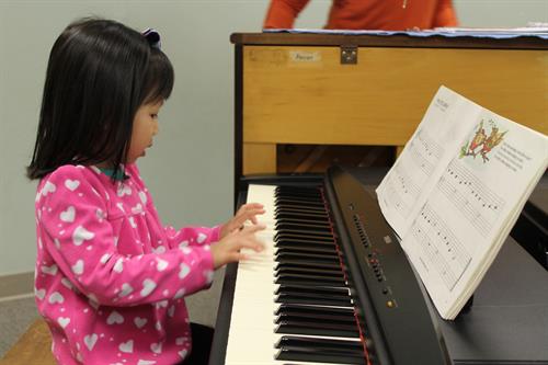 Kids learning and playing piano