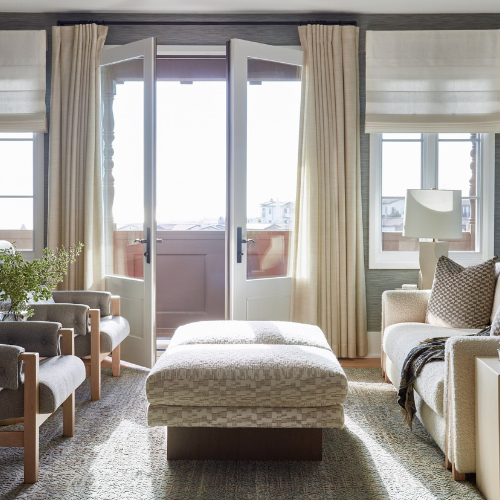 Living room with drapery and outside mounted Roman shades