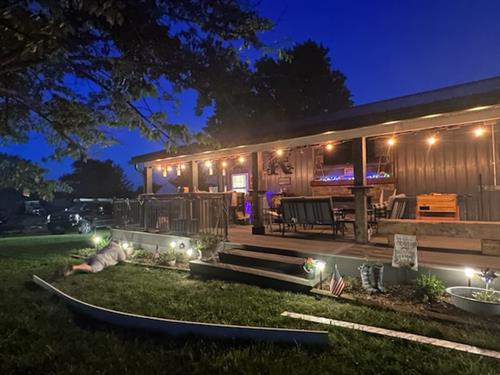 Custom Outdoor Living Space including composite decking, outdoor fireplace with stone and custom bar.