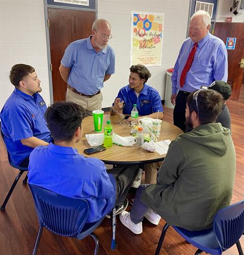 President Rollins and staff member Mike Dewberry visit with students during one of our National Hispanic Month events!