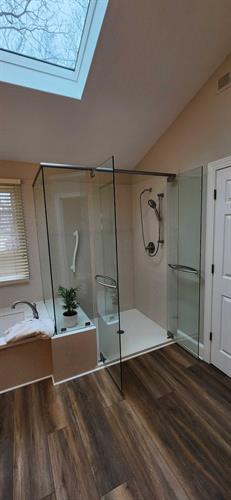 Corian shower system with a custom glass shower enclosure.