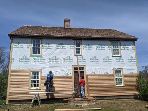 This 18th Century reproduction house was a really neat house to work on.  This unique home received new beveled cedar siding in  and a new heavy hand split shake roof.  Love the smell of cedar!