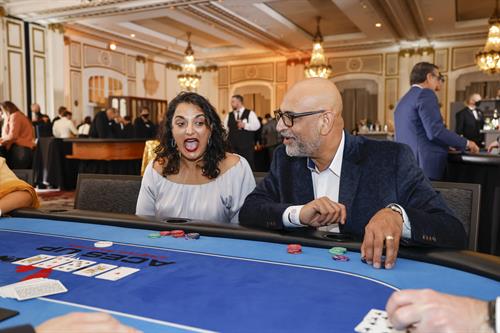 Excited poker player at an Aces Up poker table