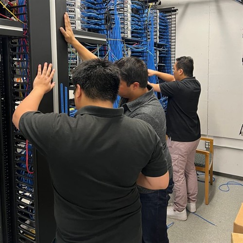 Technicians installing network switches in a server rack in Burbank, CA.