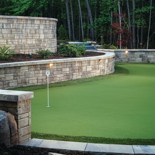 Timeless pavers paired with durable retaining walls and premium turf.
