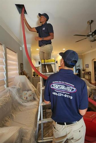 The Serveway team cleaning duct work