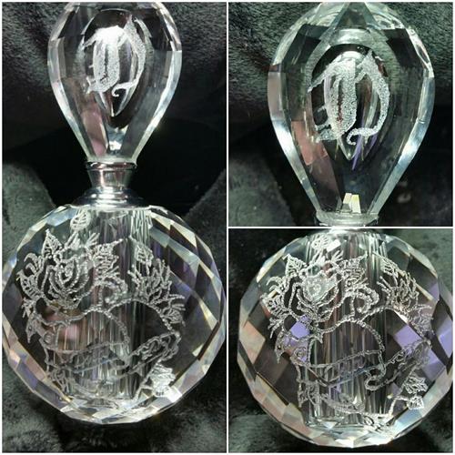 This Crystal Perfume bottle was artistic hand engraved stippling the drawing of a rose with a heart and the recipients initial on the top handle. the name is hand engraved inside the ribbon of the heart. 