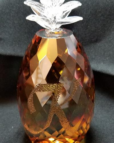 This crystal, pineapple paperweight has the recipients first initial stippled by hand engraving.