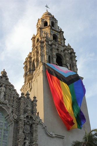 Pride flag flying vertically from the Balboa Park Museum of Us tower