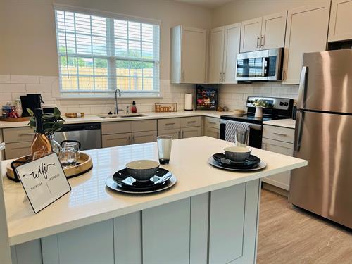 Our kitchens feature quartz countertops, soft closing drawers & cabinets, and stainless steel appliances!