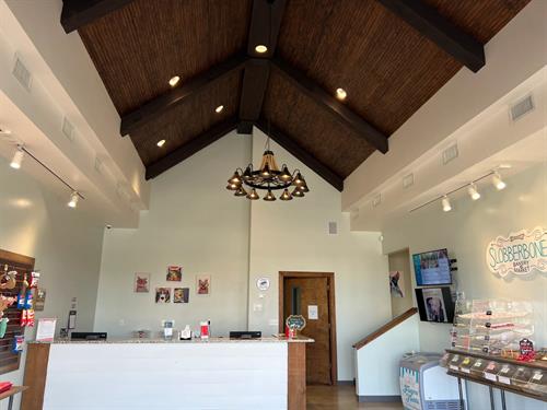 Commercial interior construction with vaulted wood beam ceiling and custom finishes completed by general contractor in Madison Alabama