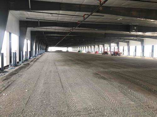 Distribution terminal interior construction with concrete slab prep steel columns and dock leveler installation by commercial general contractor