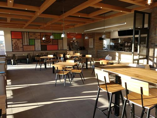 Restaurant interior construction with custom wood ceiling and commercial kitchen buildout by general contractor