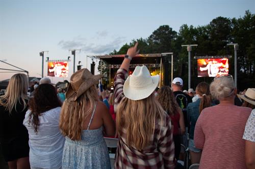 Patrons with cowboy hats at a country music performance at the Freeman Arts Pavilion.