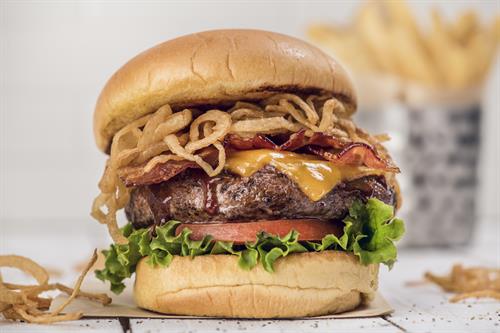 BBQ Bacon Cheeseburger: 1/2-lb fresh steak burger, seasoned and seared with a signature spice blend, topped with house-made barbecue sauce, crispy shoestring onions, Tillamook cheddar cheese, applewood bacon, leaf lettuce and vine-ripened tomatoes.