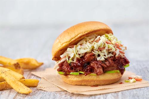 BBQ Pulled Pork Sandwich: Hand-pulled smoked pork with our house-made barbecue sauce, served on a toasted fresh bun with coleslaw and sliced Granny Smith apples. 