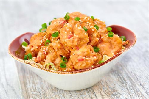 One Night in Bangkok Spicy Shrimp: 8oz of crispy shrimp tossed in a creamy, spicy sauce, topped with scallions and sesame seeds served on a bed of coleslaw. 