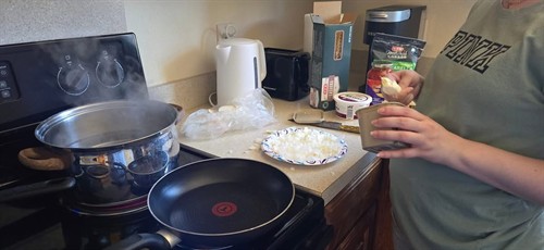 Learning to cook, while living in the Launch Pads Program.