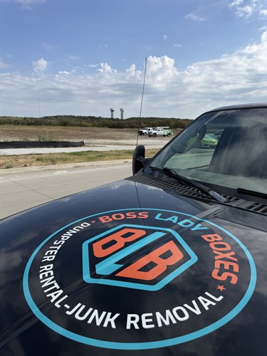 Boss Lady Boxes logo on our truck hood — women-owned dumpster rental and junk removal serving Cleburne and Johnson County.