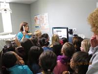 Demonstrating the intra-oral camera to a school field trip group