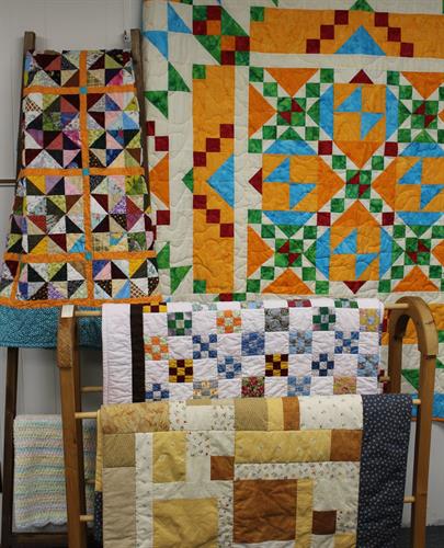 Cindy Asiala, Myla Dinger, Beverly Fennell, Sally King and Sandra Van Donkleaar  show beautiful quilts.