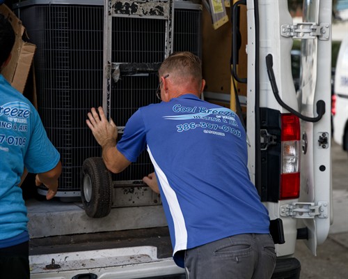 Our technicians installing and transporting HVAC equipment for a new customer installation.