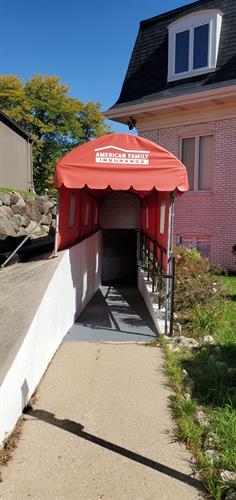 West Office: Enter through red awning in back of building 