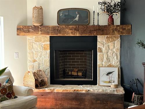 This reclaimed white oak mantel was custom crafted and installed for a customer, adding timeless rustic charm and character to their cozy fireplace setting.