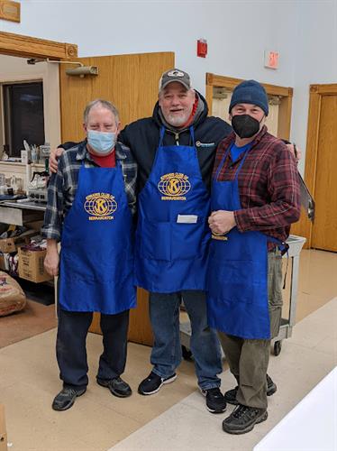 Dan Devine and boys from kiwanis  showing off printed aprons