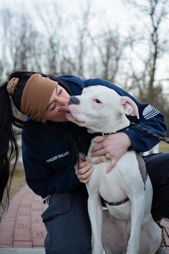 Shelter Manager, Savannah, with Eeyore, a pup saved by our Department of Animal Protection after being abandoned. He's thriving in a loving home!