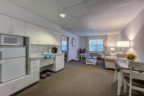 The Bellmont - Our most popular one-bedroom apartment style - the kitchenette & living room.