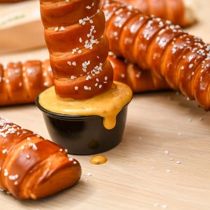 The Auntie Anne’s® Footlong Pretzel is a twist on Auntie Anne’s® signature pretzel, baked to tasty golden-brown perfection and ready to share. Served warm and topped with just the right amount of butter and salt, it’s a savory sidekick sensation. Enjoy every soft and wonderful bite.