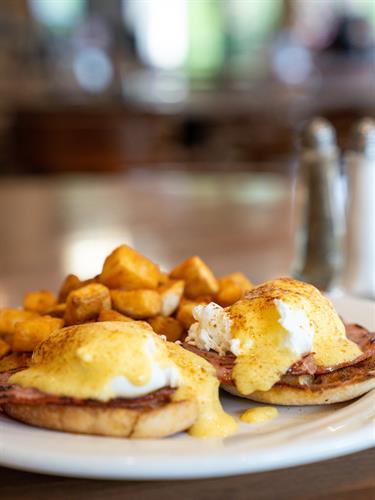 Classic Eggs Benedict — Breakfast Served Daily at LedgeStone Grille  Perfectly poached eggs, savory Canadian bacon, and rich hollandaise sauce served on a toasted English muffin, paired with golden breakfast potatoes—just one of the many delicious breakfast options waiting for you at LedgeStone Grille. Open to the public and proudly serving breakfast daily near Table Rock Lake.