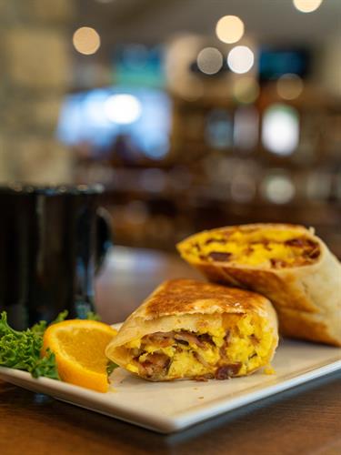 Hearty Breakfast Burrito — A Morning Favorite at LedgeStone Grille  Packed with fluffy scrambled eggs, savory breakfast meats, and melted cheese, our breakfast burrito is grilled to perfection and served fresh each morning at LedgeStone Grille. Open to the public and serving breakfast daily near Table Rock Lake—start your day with bold flavor and a great cup of coffee.