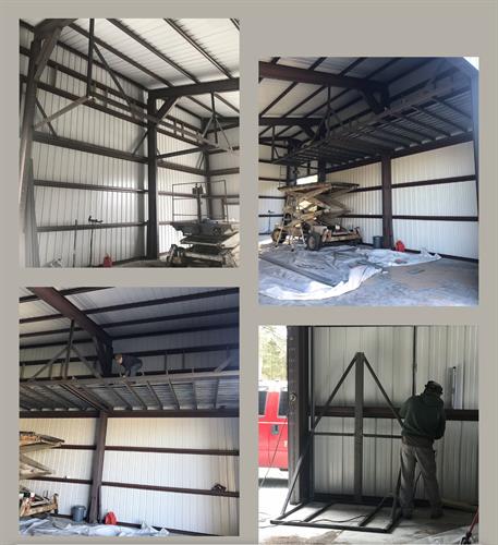 Mezzanine storage in shop with wall platform lift hoist system Mezzanine storage in shop with wall platform lift hoist system