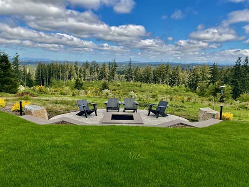 Modern patio with fire pit overlooking the valley by Greenhaven Landscapes