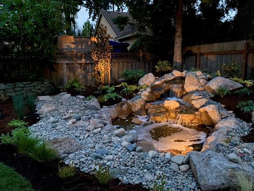 Backyard water feature by Greenhaven Landscapes