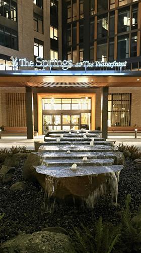 The Springs at the Vancouver Waterfront water feature at night by Greenhaven Landscapes