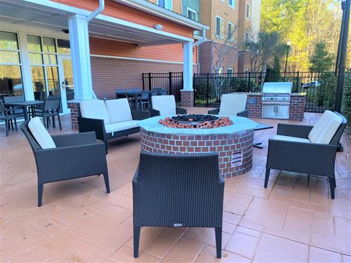 Beautiful new outdoor lounge and patio where guests relax by our fire pit and fire-up the grill!