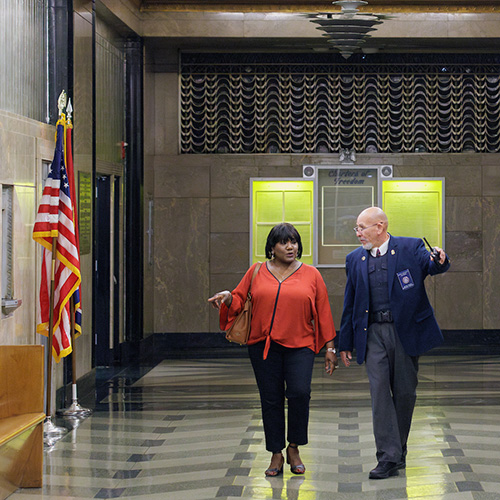 Walden Security Court Security Officer escorts visitor through courthouse