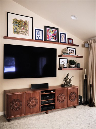 Custom shelving and media center designed to maximize storage, organization, and timeless style.