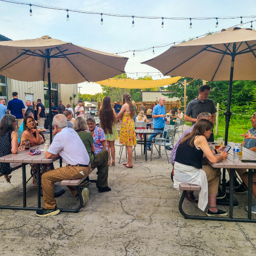 Outdoor dining on the Nature’s Edge Terrace at Artisanal Brew Works in Saratoga Springs, a popular destination for food, drinks, and events