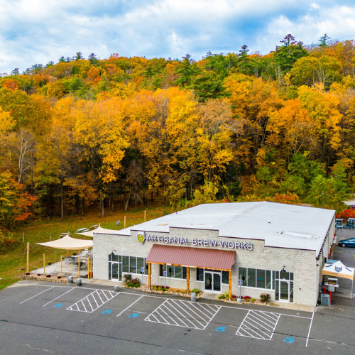 Artisanal Brew Works in Saratoga Springs featuring outdoor dining on the Nature’s Edge Terrace surrounded by forest views