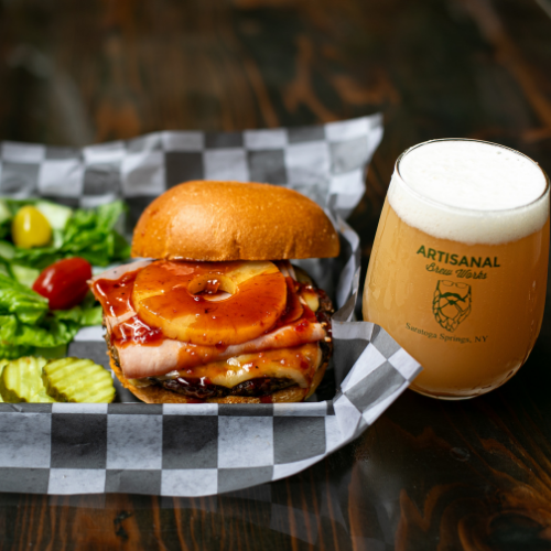 Aloha burger with Wagyu beef, grilled pineapple, and BBQ sauce at Artisanal Brew Works, a Saratoga Springs restaurant with a full menu