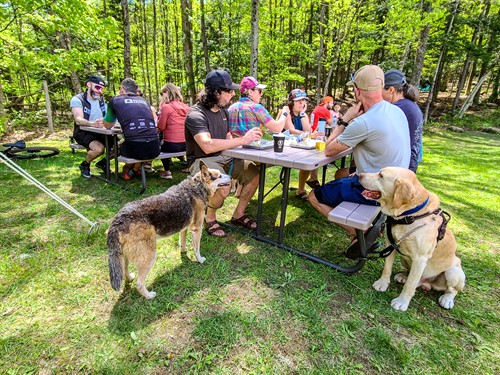 Outdoor dining at Artisanal Brew Works in Saratoga Springs featuring a spacious, dog-friendly terrace where guests enjoy great food, drinks, and live music just steps from local hiking and mountain biking trails.