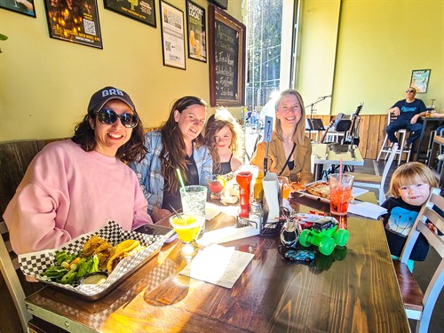 Guests enjoying dining at Artisanal Brew Works in Saratoga Springs with a relaxed, family-friendly atmosphere and live music nearby.