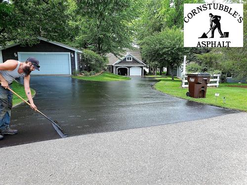 One of our crew sealing a driveway BY HAND which is what sets us apart from our competition.