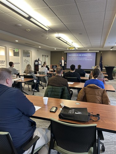 Business leaders attending a Thought Partner Services workshop on the power of everyday interactions and their impact on customer experience.